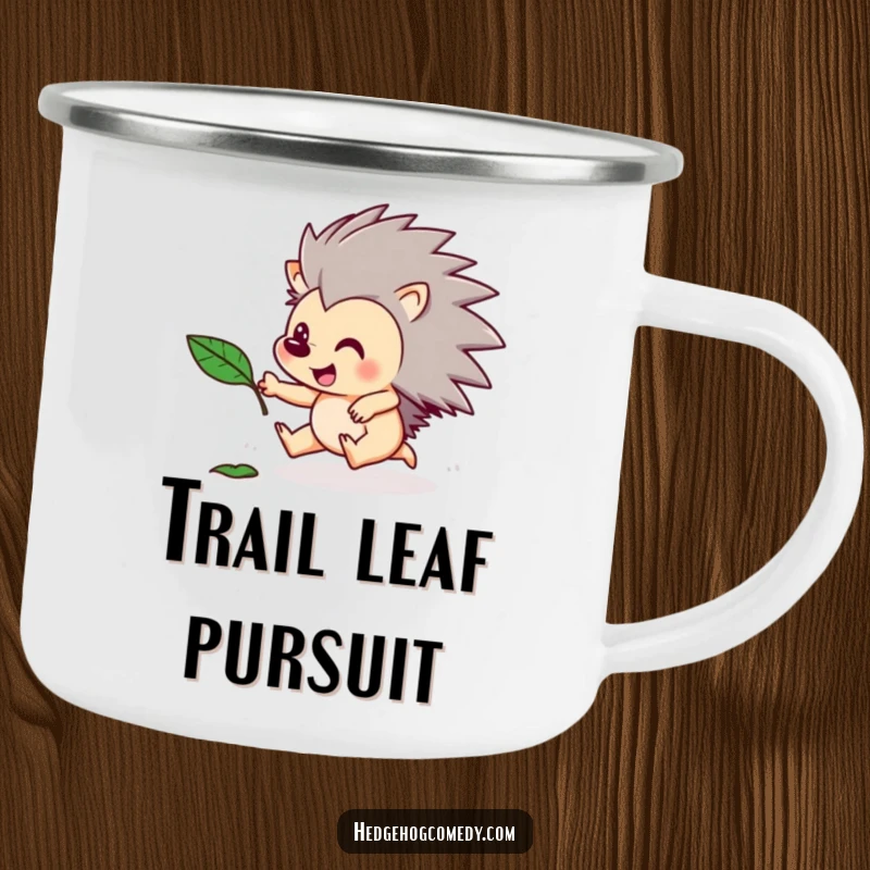 Funny camping mug with a playful hedgehog character chasing a floating leaf. Humorous and durable for outdoor use.