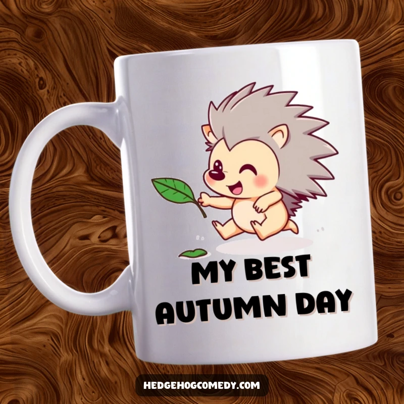 Funny mug showing a happy hedgehog character enthusiastically chasing a floating autumn leaf. Playful and humorous animal art.