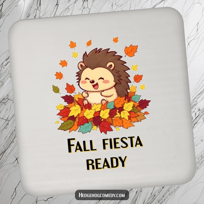 Funny drink coaster featuring a happy hedgehog rolling in a pile of colorful autumn leaves, adding seasonal charm and table protection.