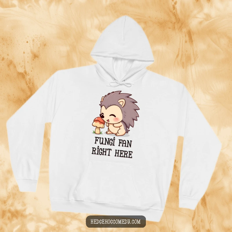 Funny hedgehog with an excited expression sniffing a mushroom on a cozy hoodie, perfect for anyone who loves the outdoors.