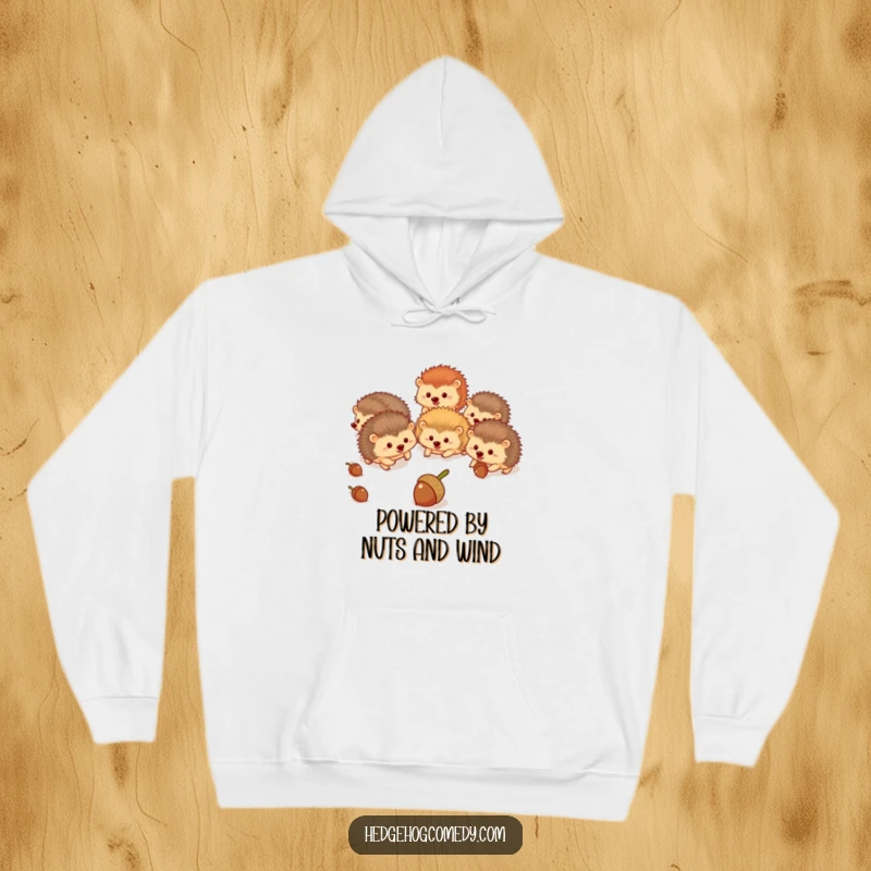 Funny hedgehogs energetically chasing acorns across a cheerful woodland landscape, a humorous and cozy hoodie.