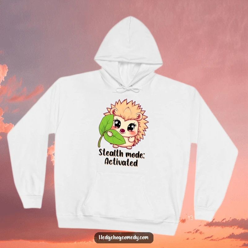 Funny hoodie graphic depicting a hedgehog with big eyes peeking from behind a leaf, conveying humorous curiosity and cozy comfort.