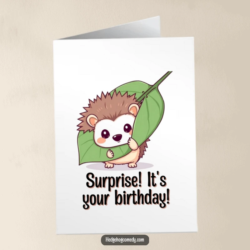 Funny Free Printable Birthday Card showing a mischievous hedgehog hiding behind a large leaf, playfully peeking out, ready for fun.
