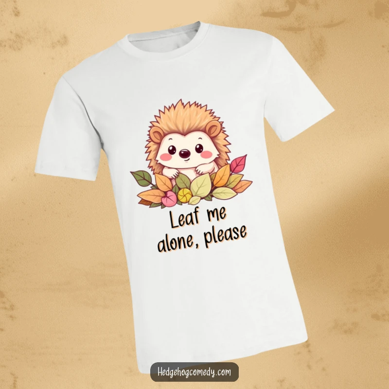 Funny T-Shirt featuring a cute Kawaii hedgehog with a friendly smile, peeking out from a cozy pile of leaves.