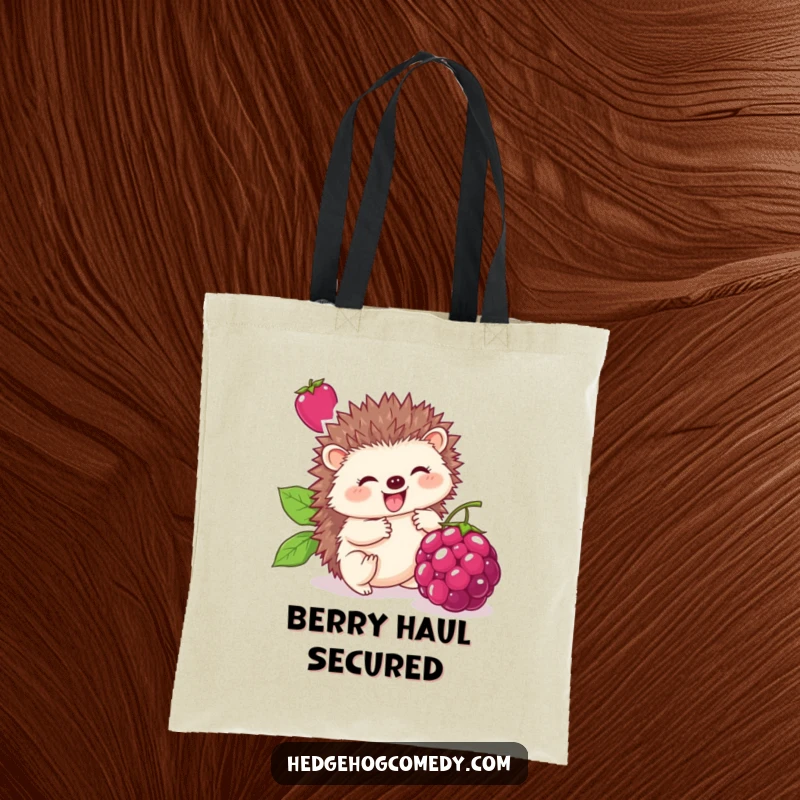 Funny tote bag featuring a cute hedgehog happily rolling a large berry, perfect for carrying items with a touch of humorous sweetness.