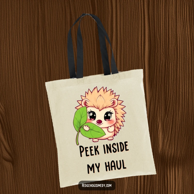 Funny tote bag featuring a wide-eyed hedgehog peeking from behind a leaf, perfect for carrying items with a touch of humorous mystery.